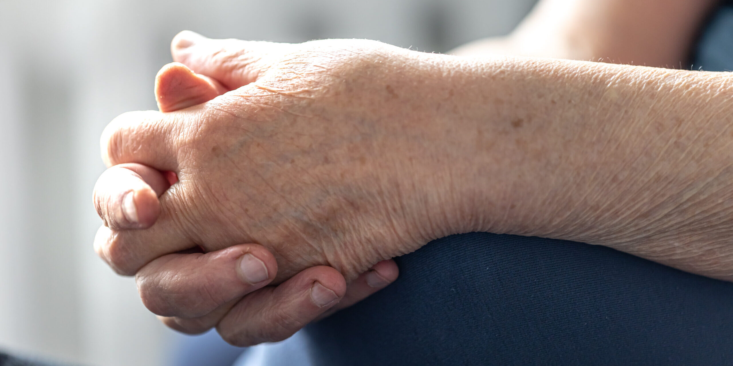 Close-up, the hands of an elderly woman.